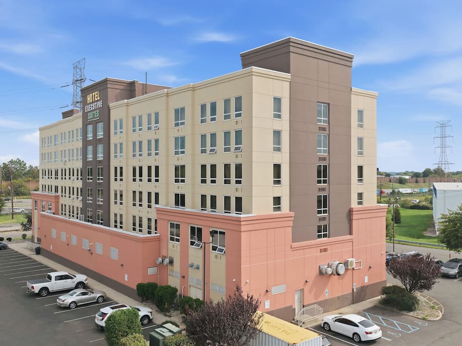 A multi-story hotel with a prominent sign indicating executive suites.