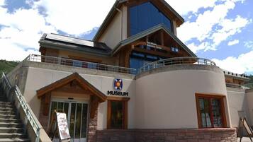 A museum with a modern architectural design, featuring a prominent entrance and a balcony.