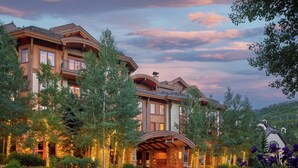 A large, multi-story hotel with a prominent entrance and a landscaped garden.