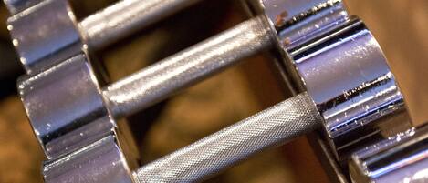A close-up of a metallic, segmented object with a textured surface, possibly a part of a piece of furniture or equipment.