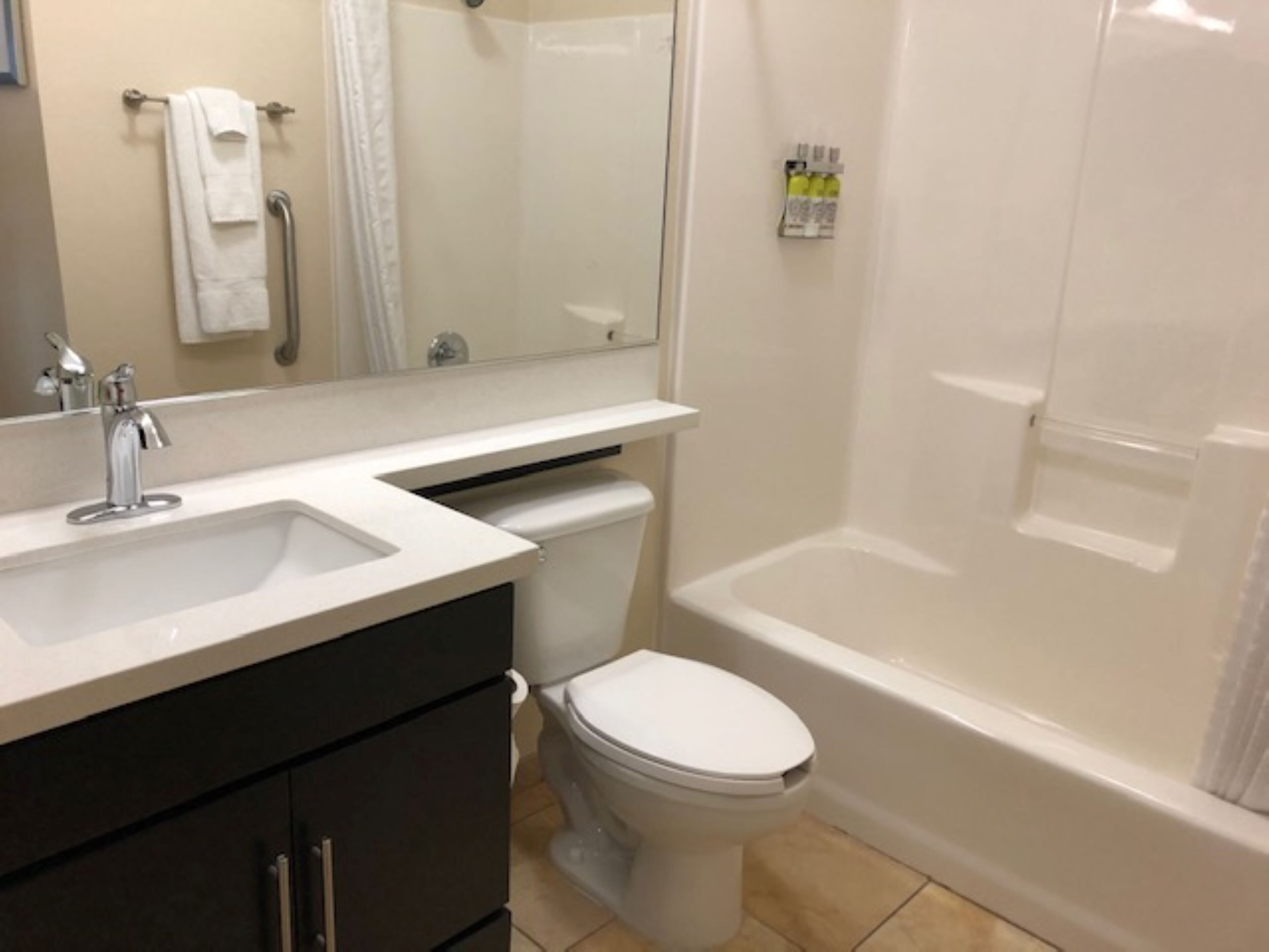A bathroom with a sink, toilet, and bathtub.