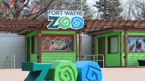 A zoo entrance with a sign reading "FORT WAYNE ZOO" and animal murals on the doors. - Candlewood Suites Fort Wayne by IHG (Fort Wayne)