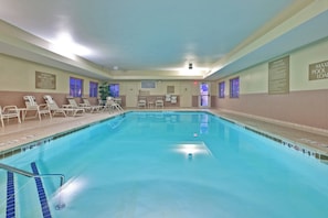 An indoor swimming pool with clear water, marked depth lines, and a lifeguard chair. - Candlewood Suites Fort Wayne by IHG (Fort Wayne)