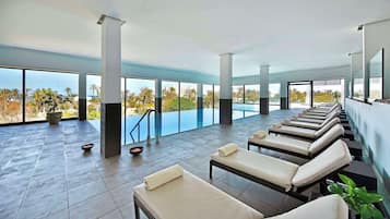 Relax by the pool with a view of lush palm trees and tropical landscape.