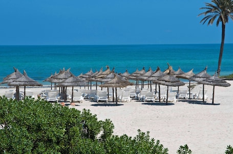 Private beach, white sand, beach bar. Radisson Blu Palace Resort & Thalasso, Djerba