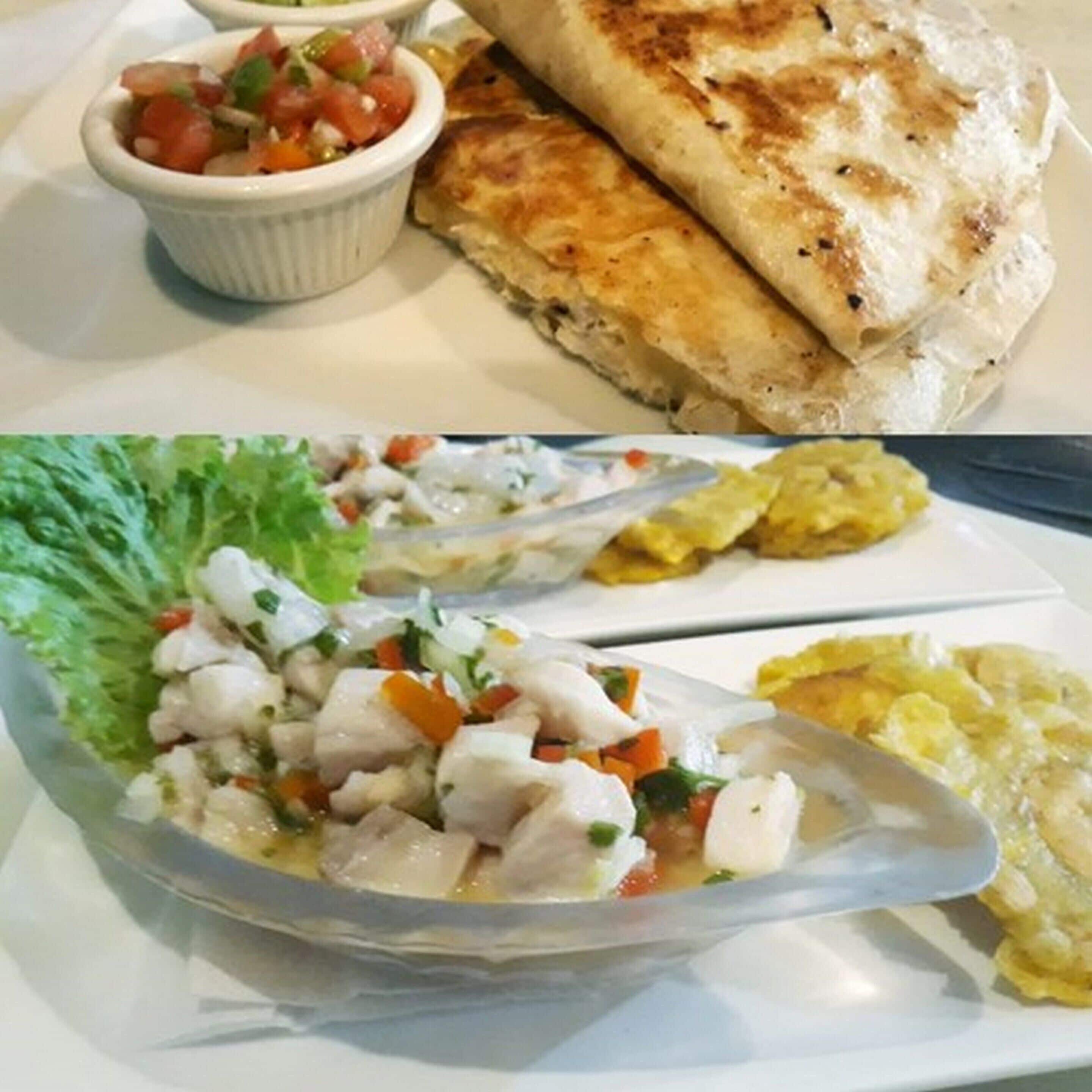 A meal with a flatbread, a salad, and a bowl of soup.