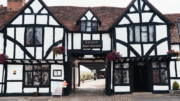 A traditional Tudor-style building with a sign reading "Can Park Hotel Entrance." - The Kings Arms Hotel (Amersham)