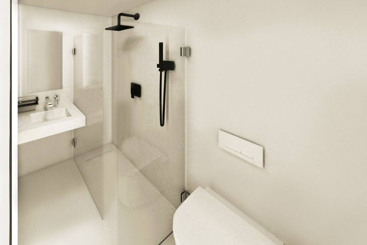 A modern bathroom with a glass shower enclosure, a white sink, and a toilet.