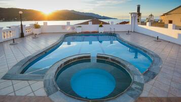 Una piscina con vistas al mar y a las montañas.