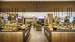 A buffet area with various food items and a central plant. - Maistra Select Island Hotel Istra (Rovinj)