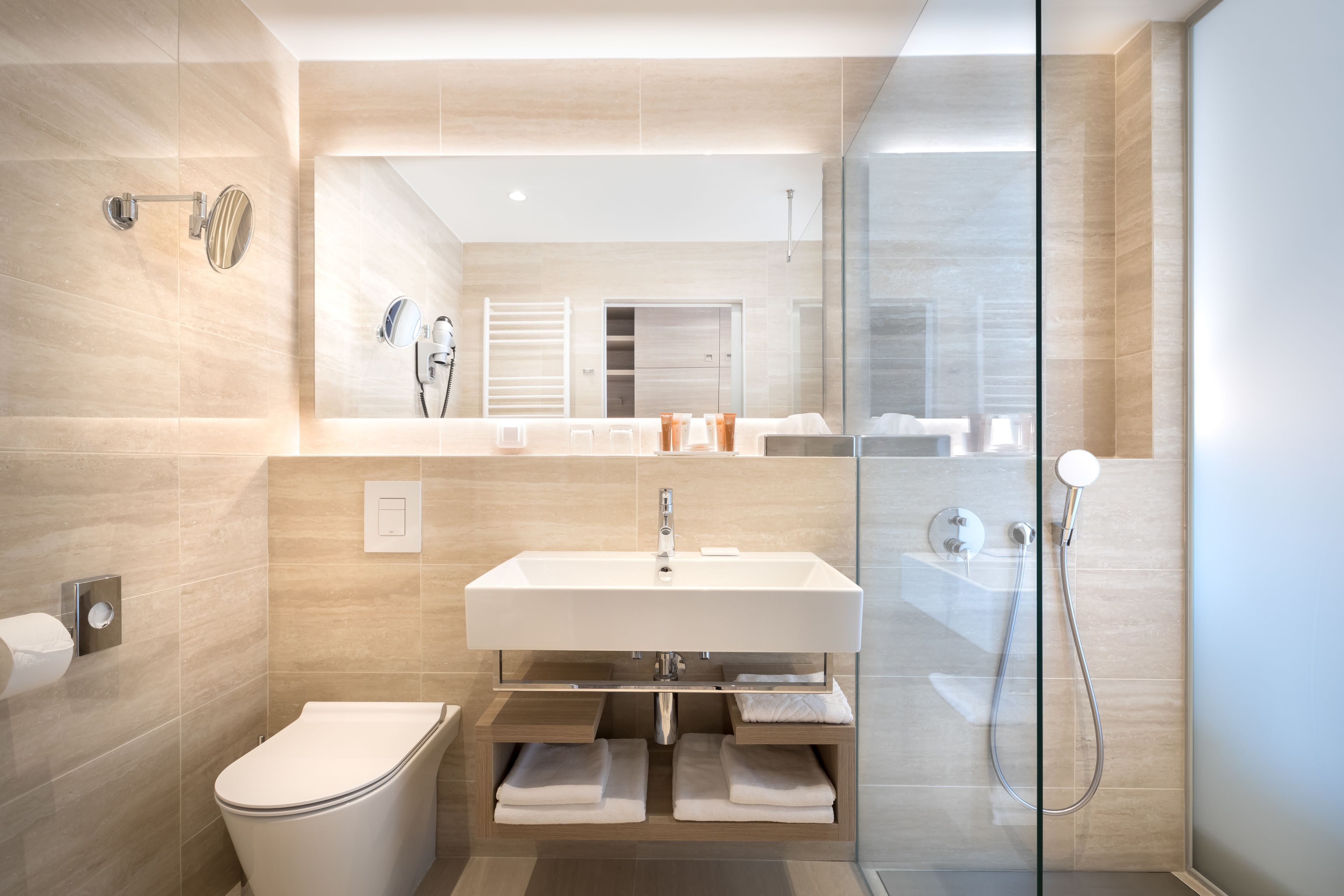 Un baño moderno con inodoro, lavabo y ducha.
