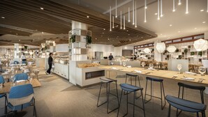 A modern restaurant with high ceilings, wooden paneling, and a central bar area. - Eden Hotel by Maistra Collection (Rovinj)