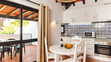 Standard Apartment, 1 Bedroom (or Villa) | Private kitchen | Fridge, microwave, cookware/dishes/utensils, dining tables