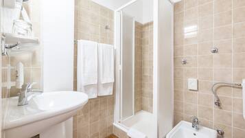 A bathroom with a sink, a shower, and a bathtub.