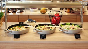 A buffet with various dishes, including salads and pasta, in a modern kitchen setting. - Maistra Select Funtana All Inclusive Resort (Funtana)