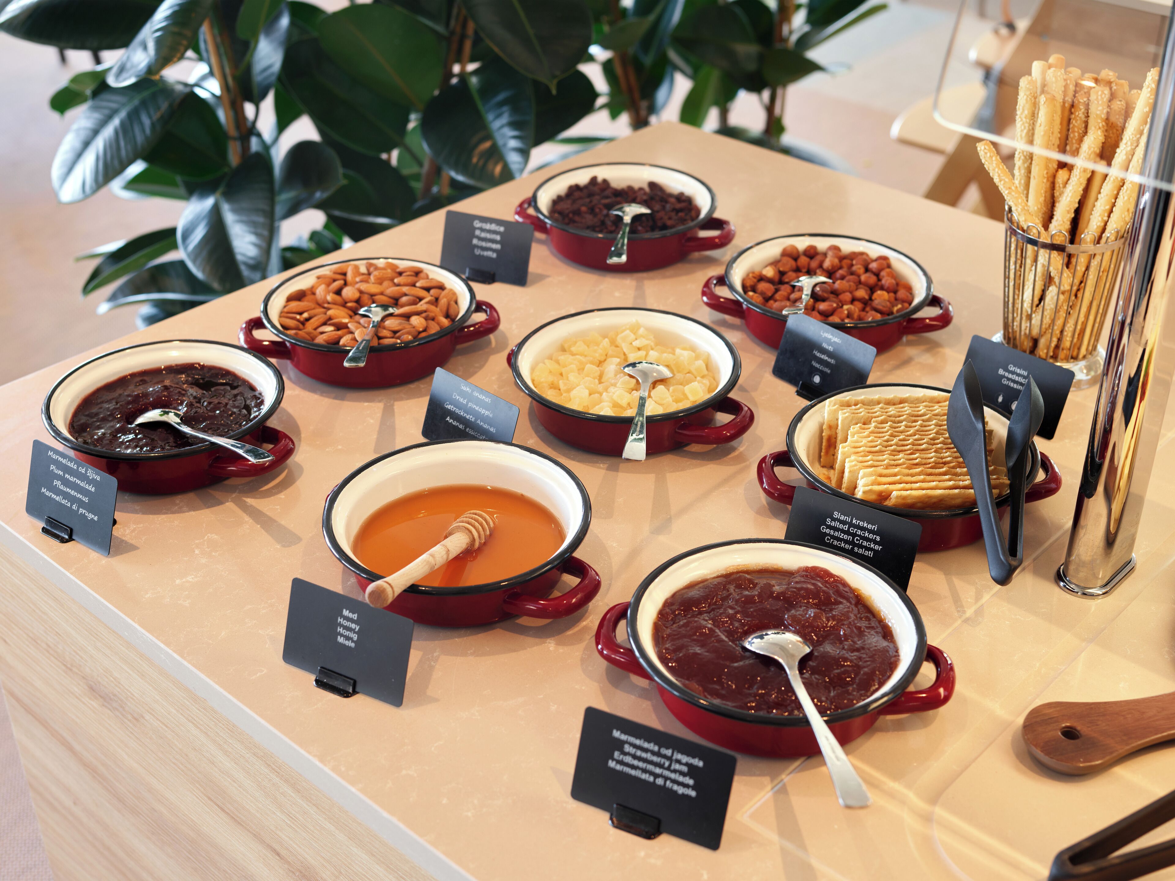 A buffet with various dishes including fruits, nuts, and desserts.