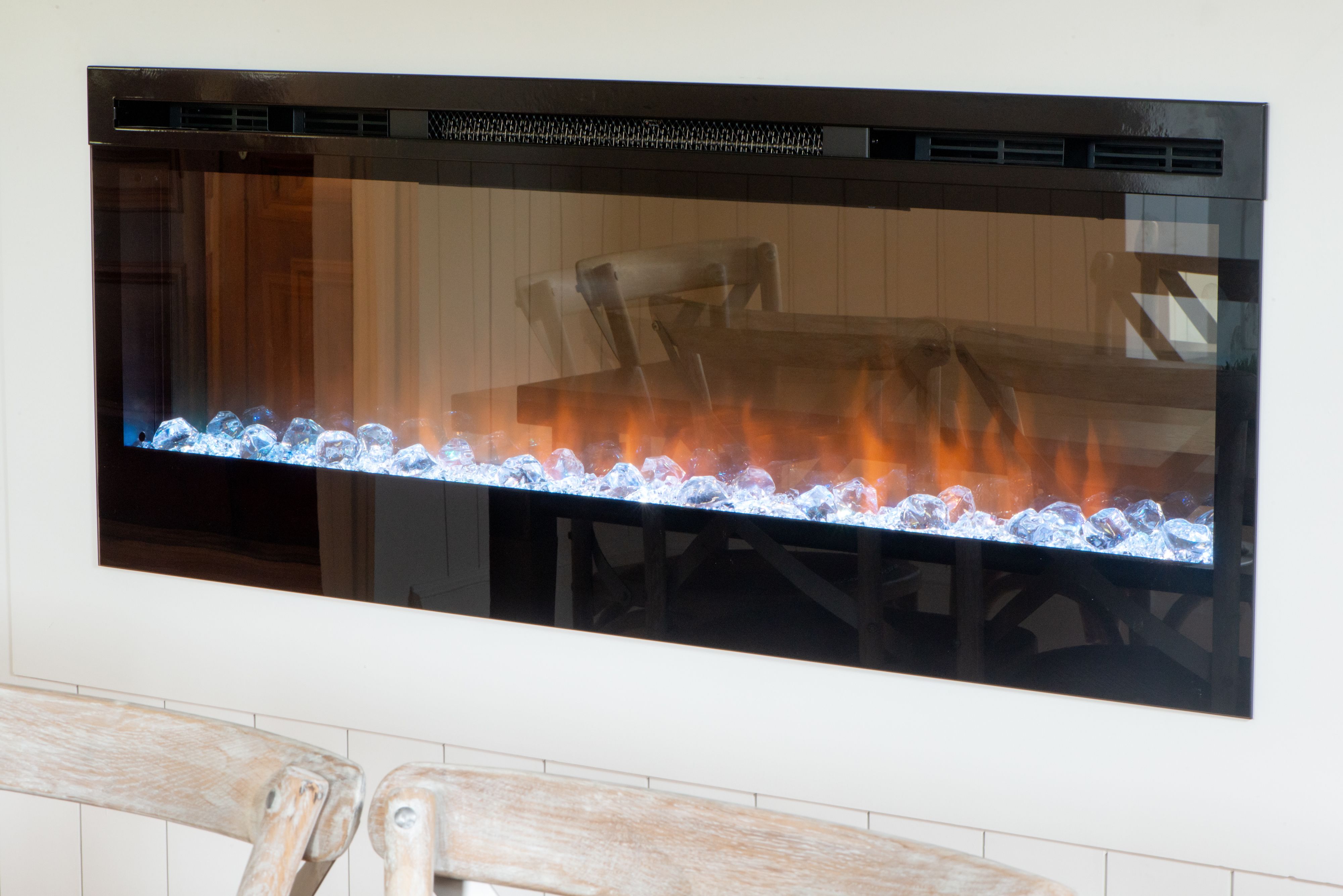 A modern kitchen with a built-in stove and a glass backsplash.