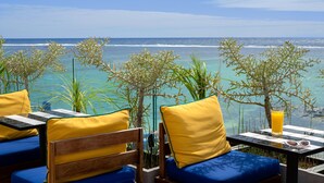 A seaside terrace with seating and a table, overlooking the ocean. - SALT of Palmar, an adult-only boutique Hotel (Belle Mare)