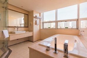 A modern bathroom with a large bathtub, a glass shower enclosure, and a large window offering a city view. - Vienna International Hotel (Beijing Niujie Guang'anmennei Subway Station Branch) (Beijing)
