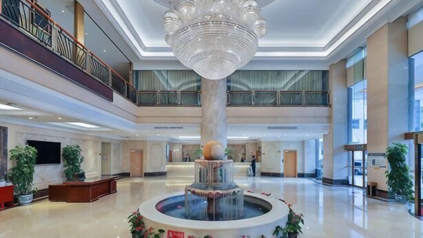 A spacious lobby with a central fountain, multiple floors, and a balcony. - Vienna International Hotel (Beijing Niujie Guang'anmennei Subway Station Branch) (Beijing)