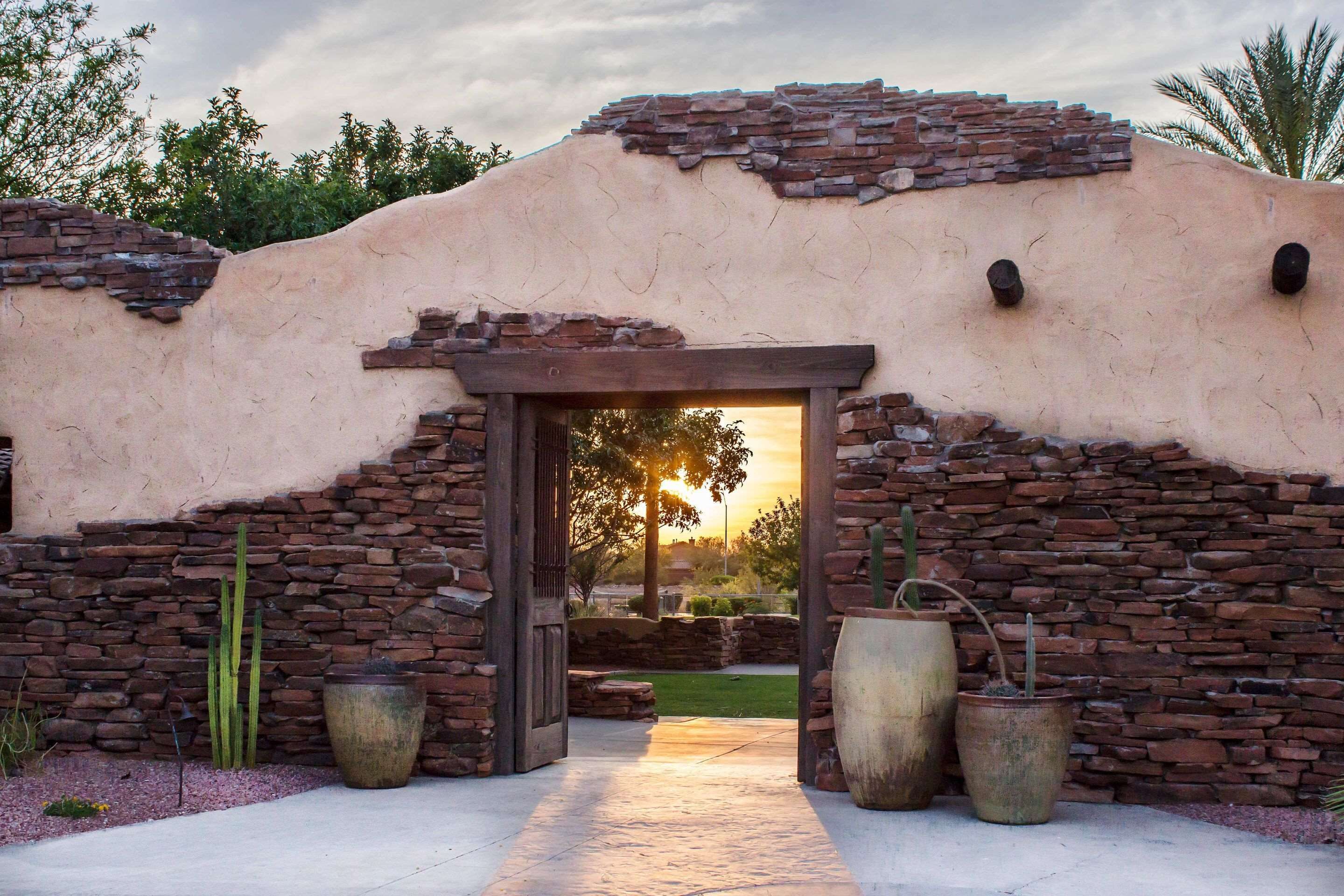 A building entrance with a stone facade and a wooden archway.