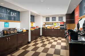 A bakery counter with various baked goods and a waffle maker. - Hampton Inn & Suites Lake City (Lake City)