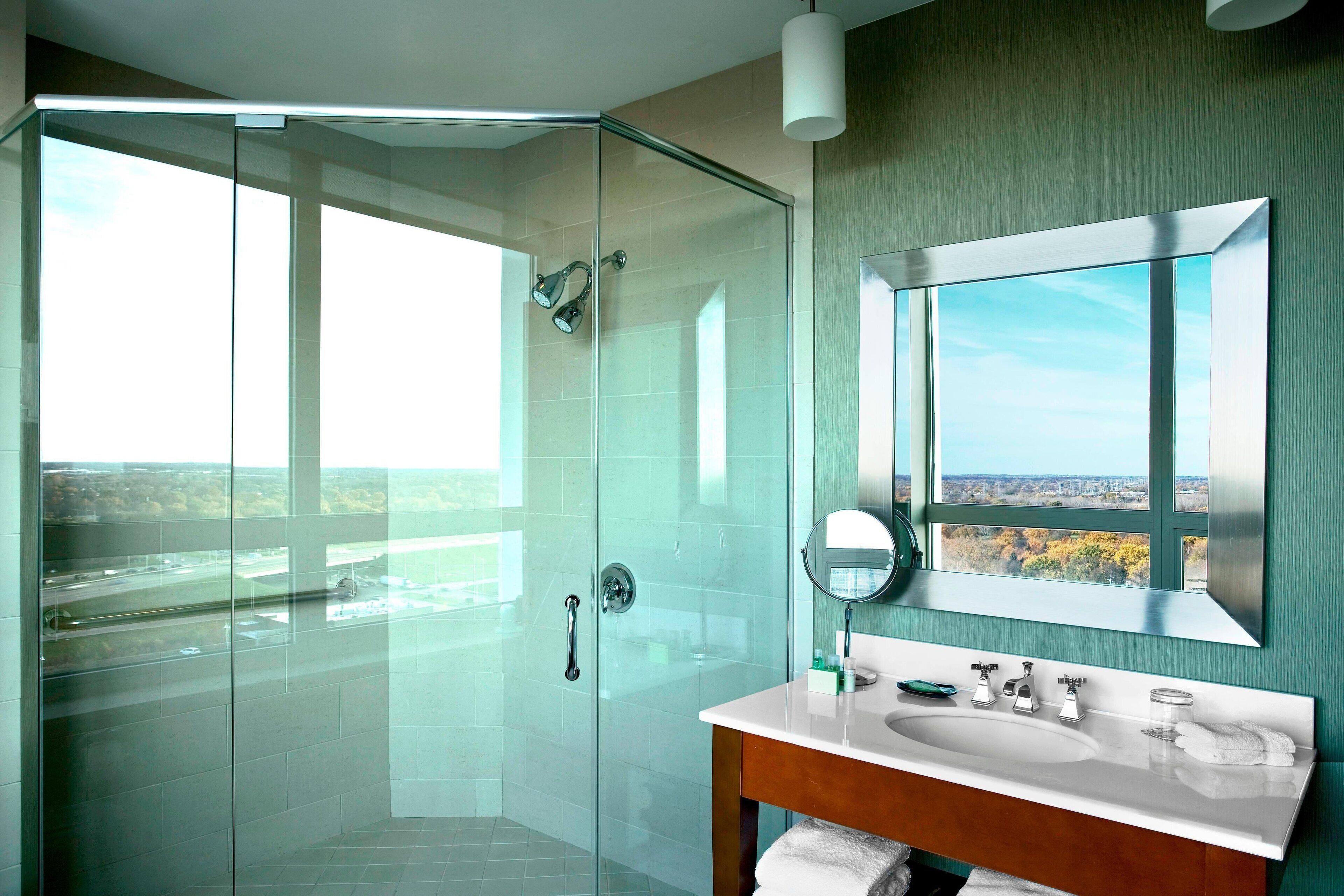 combined shower/bathtub, designer toiletries, hair dryer, bathrobes