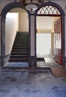 A staircase leading to a door with a ramp at the bottom.