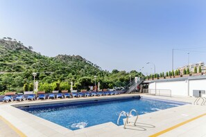 Seasonal outdoor pool, pool umbrellas, pool loungers