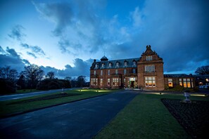 A large, historic building with a symmetrical facade, multiple windows, and a prominent central tower. - Holiday Inn Dumfries by IHG (Dumfries)