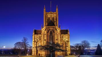 A large, illuminated church with a prominent tower and detailed architecture.