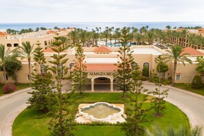 A resort with a central building labeled "ALMAZA BEACH," surrounded by palm trees and a pool area. - JAZ Almaza Beach Resort, Almaza Bay (Marsa Matrouh)