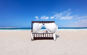 On the beach, beach umbrellas, beach towels, beach volleyball