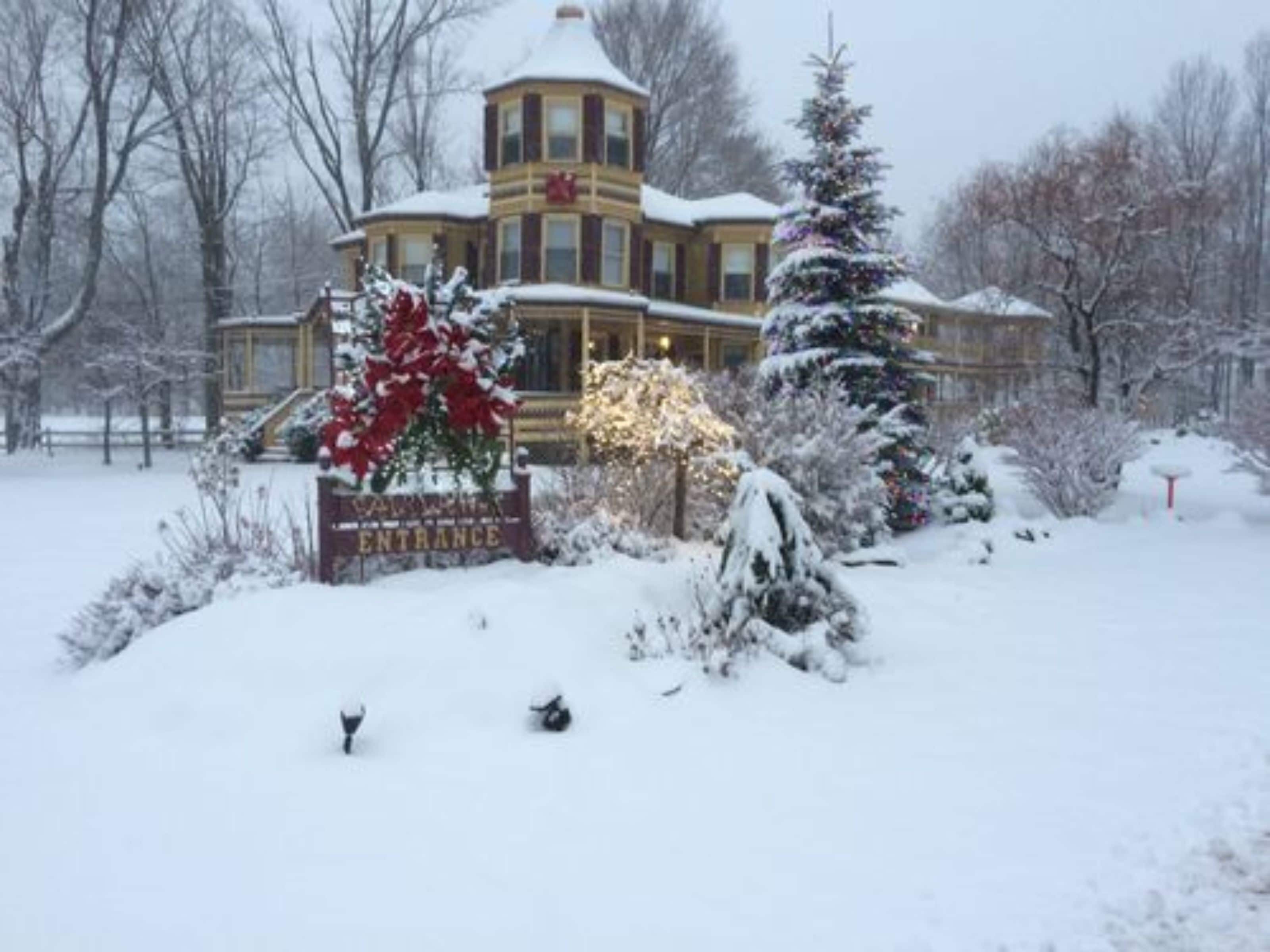 A snow-covered building with a sign reading "Entrance."