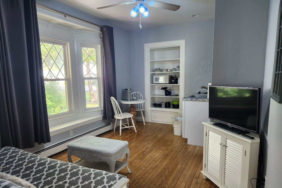 Suite monolocale, 1 camera da letto | Area soggiorno | TV a schermo piatto 32 pollici con canali via cavo, TV