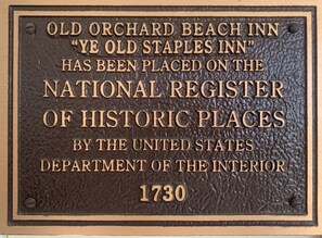 A plaque with text about the Old Orchard Beach Inn, stating it is on the National Register of Historic Places.