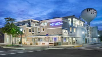 A multi-story hotel with a prominent 'COAST' sign, a water tower labeled 'Rehoboth Beach,' and a 'SIROCCO' sign.