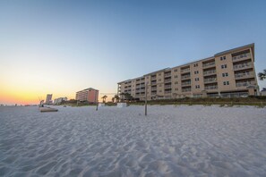 A beachfront hotel with multiple floors, balconies, and a sandy beach in the foreground. - Holiday Inn Club Vacations Panama City Beach Resort by IHG (Panama City Beach)