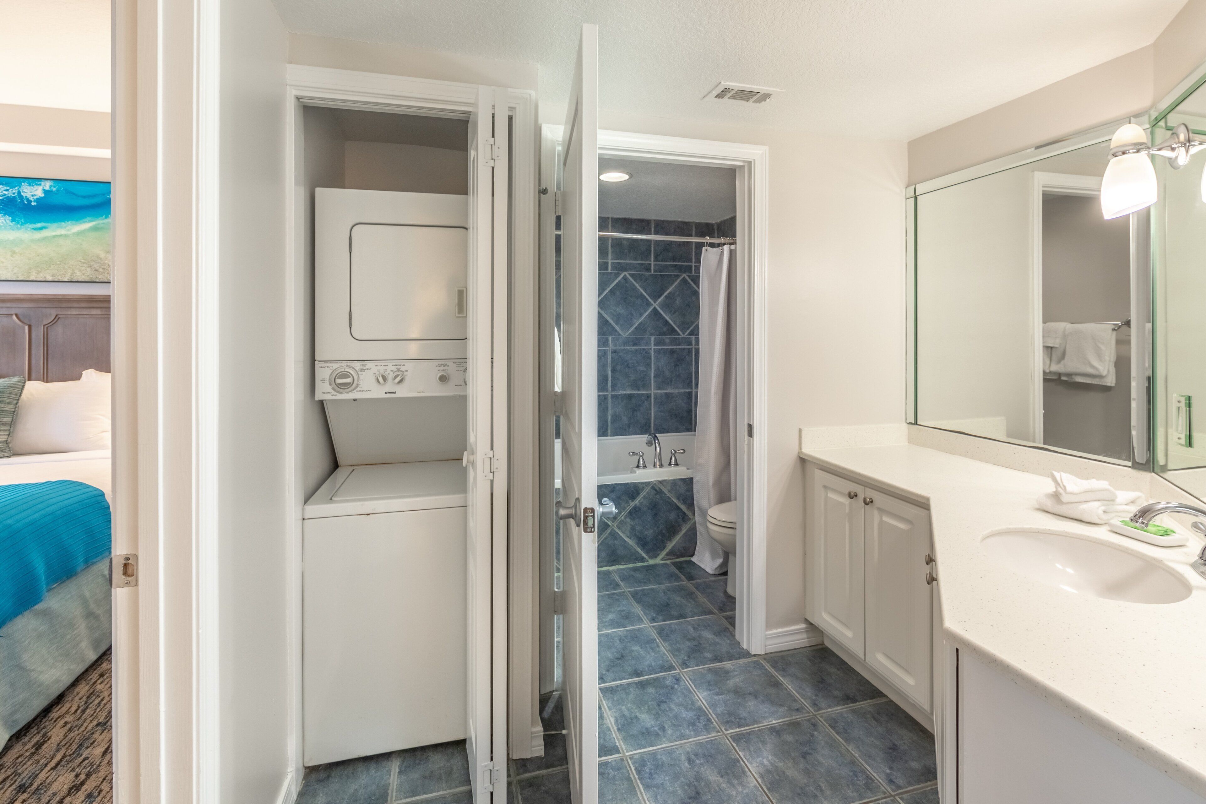 A bathroom with a white sink, a mirror, and a shower.