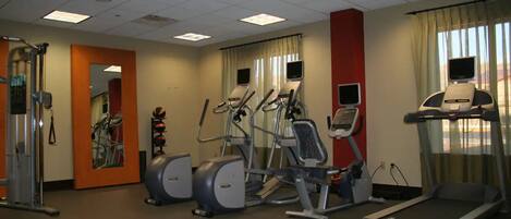A gym with treadmills, elliptical machines, and a weight machine.