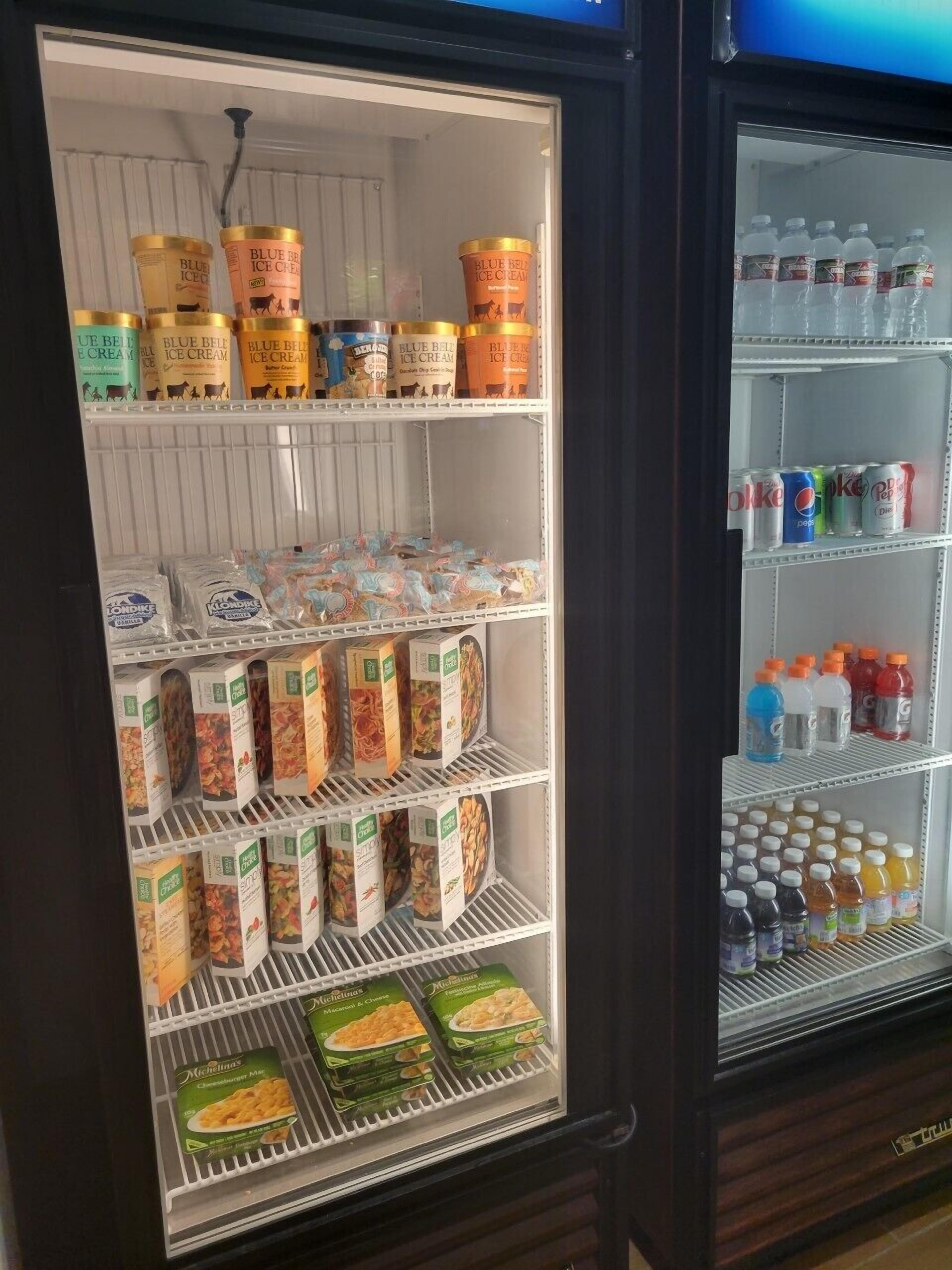 A refrigerated display case with various food items and beverages.