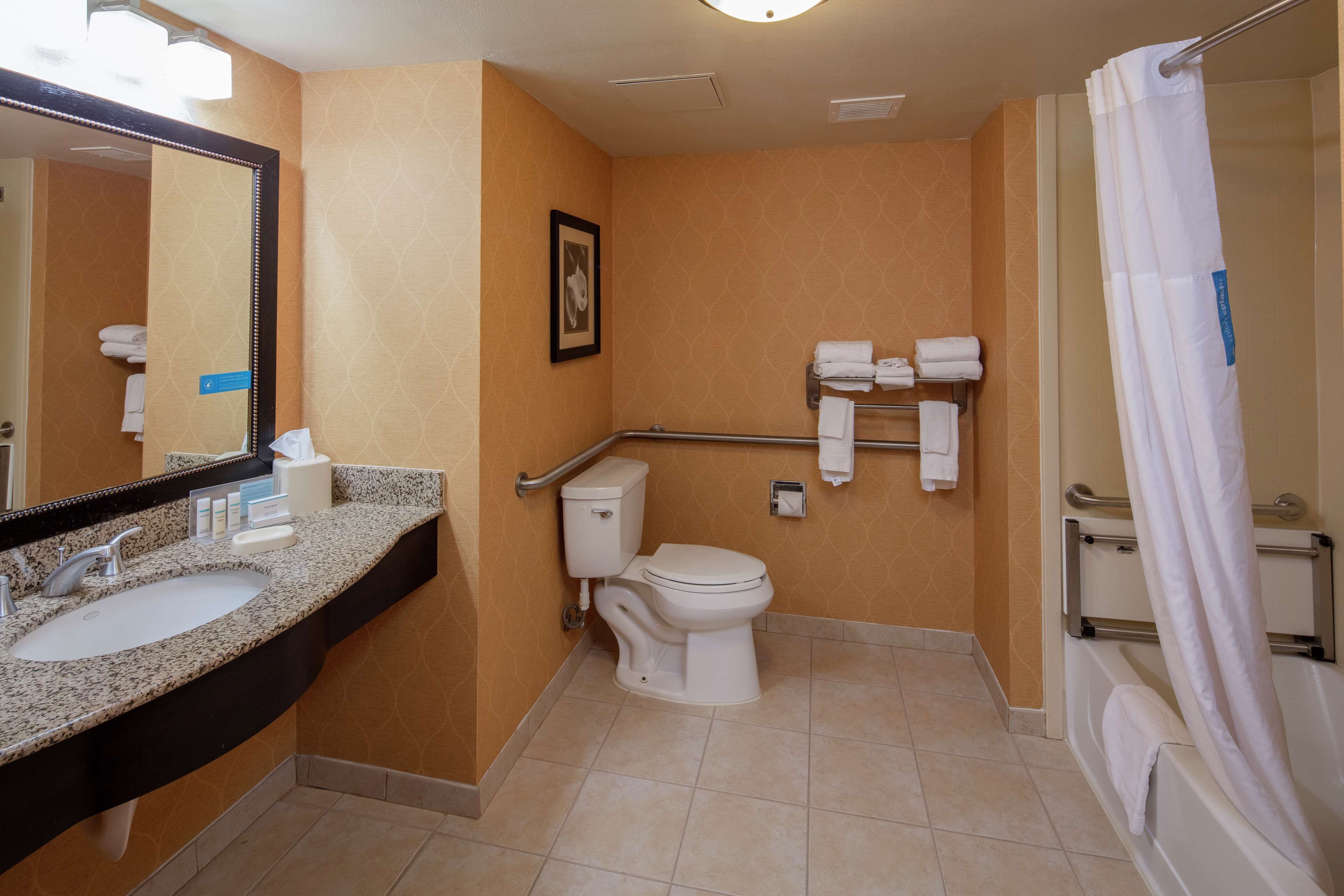 A bathroom with a sink, toilet, and shower.