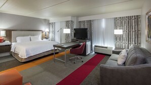 A hotel room with a bed, desk, TV, and seating area. - Hampton Inn & Suites Austin Cedar Park-Lakeline (Austin)
