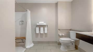 A modern bathroom with a toilet, a shower curtain, and a towel rack.