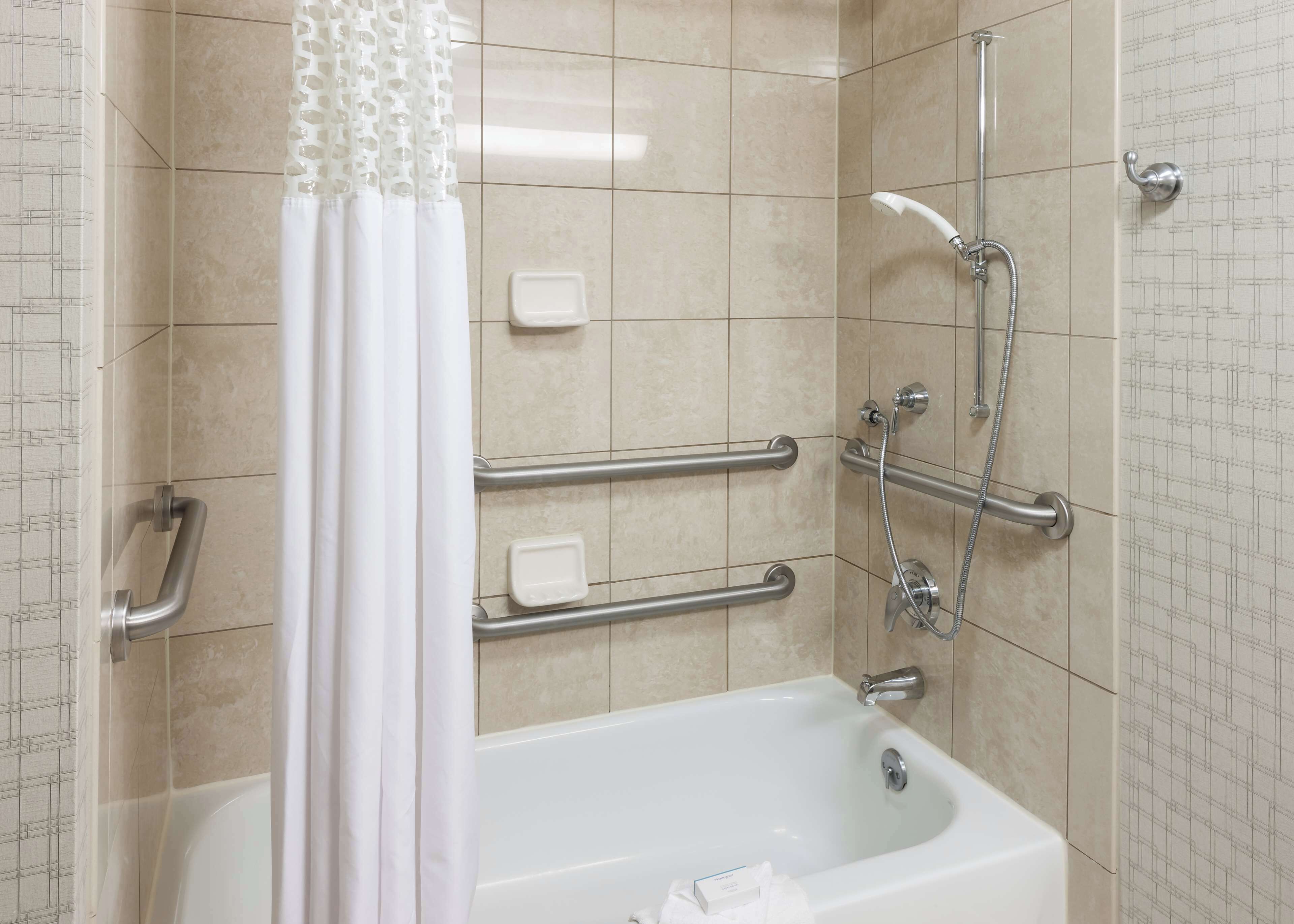 combined shower/bathtub, designer toiletries, hair dryer, bathrobes
