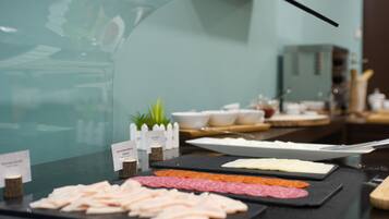 A buffet with various meats and cheeses.