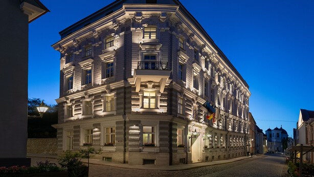 A historic building with ornate architecture, large windows, and a balcony. - Hotel Telegraaf, Autograph Collection (Tallinn)
