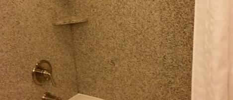 A bathroom with a bathtub, a shower, and a toilet.