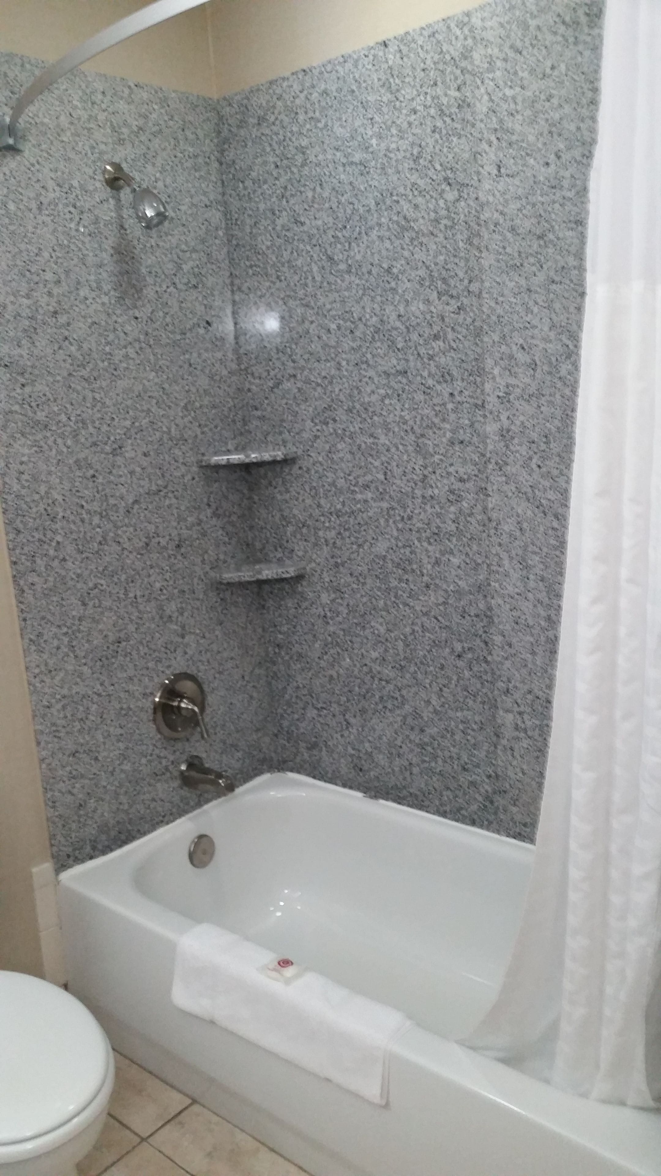 A bathroom with a bathtub, a shower, and a toilet.