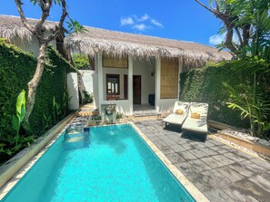 A pool area with a thatched-roof structure, a small pool, and lounge chairs. - The Lagoon Bali Pool Hotel and Suites (Legian)